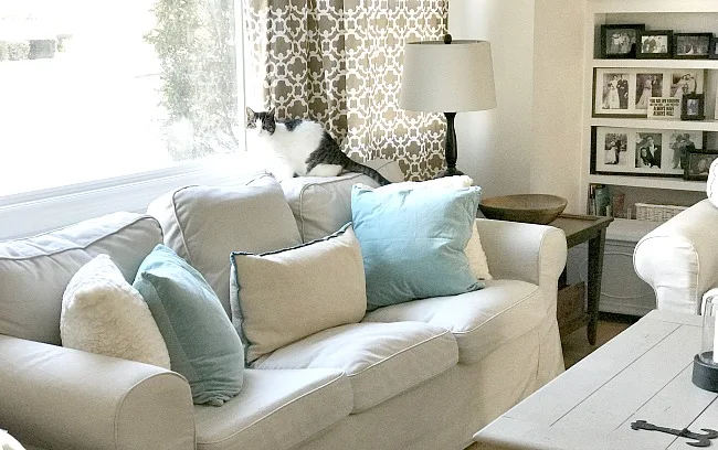 White couch with blue pillows