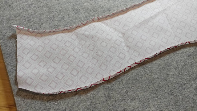 Pressing the seam allowance under to create the illusion of curved piecing