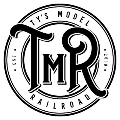 ty's model railroad black circular logo on a white background