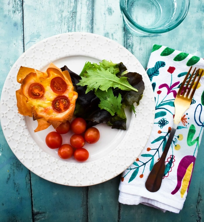 cheese and red pepper pies on a plate with salad