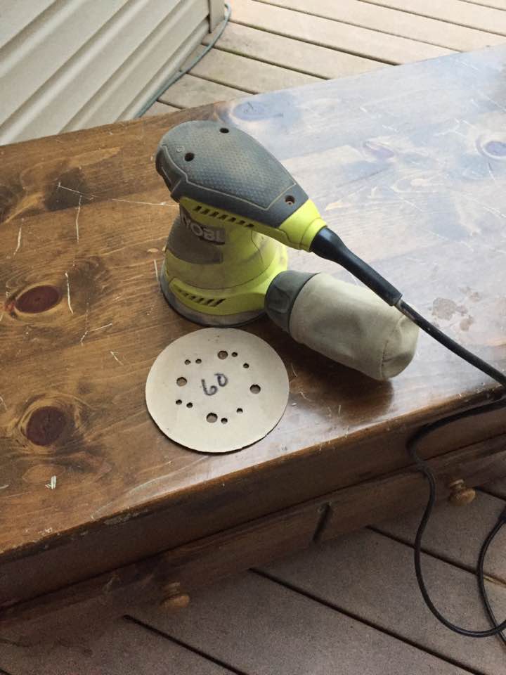 Preparing to smooth the wood with an orbital sander. Preparing to smooth the wood with an orbital sander.