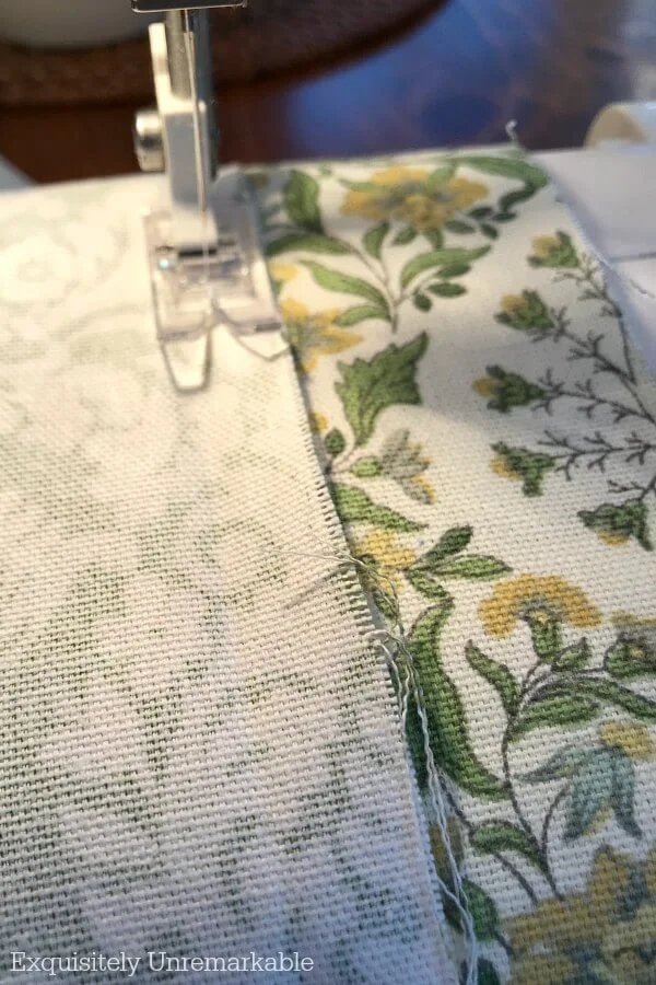 Sewing machine needed sewing a seam on a green valance