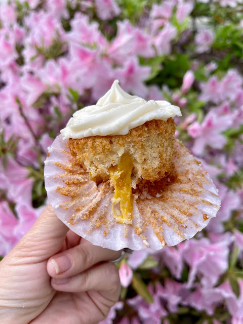 peach cupcake with white frosting