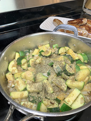 Onion and zucchini cooking in a skillet Onion and zucchini cooking in a skillet