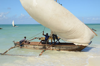 jambiani beach in zanzibar, boats with rocker at high tide