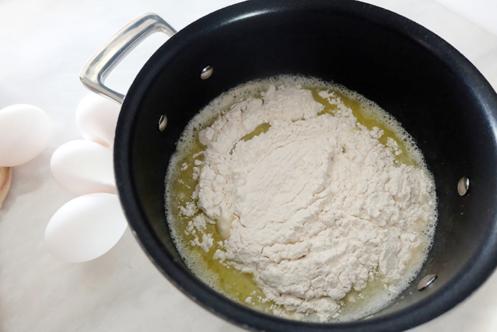 adding flour to melted butter and boiling water