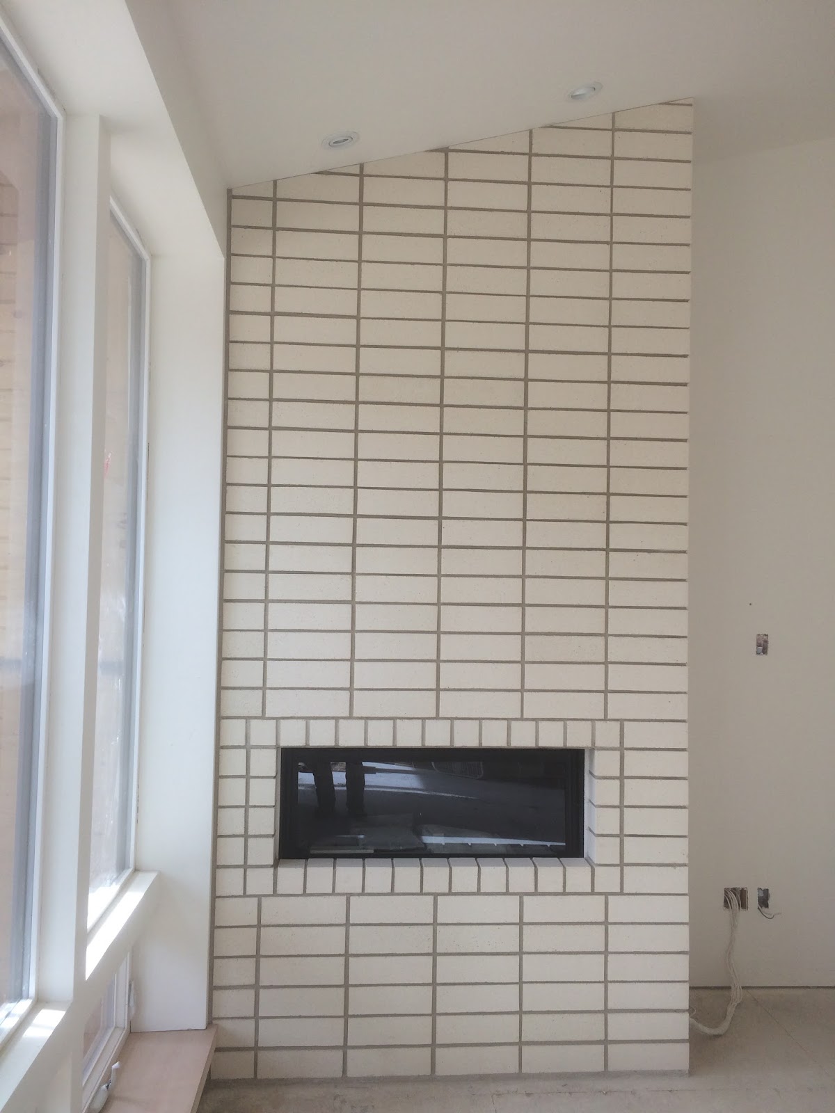 BOISINEAU MASONRY Stacked Bond Brick Fireplace in Northwest CRossing
