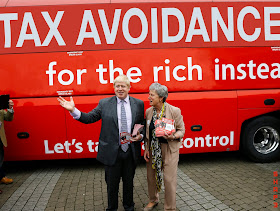 Boris Johnson stands in front of Photoshopped Brexit Bus NHS