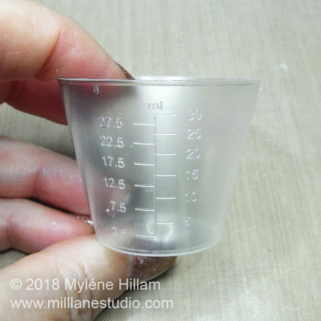 Plastic measuring cup ready for re-use.