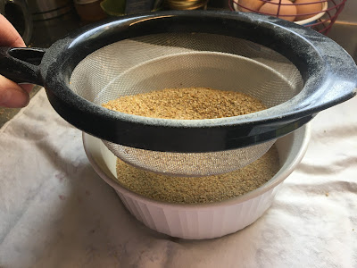 winnowing quinoa with mesh strainer
