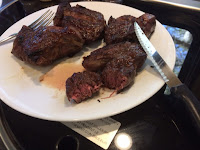 Finished steaks from UCO Flat Pack Grill