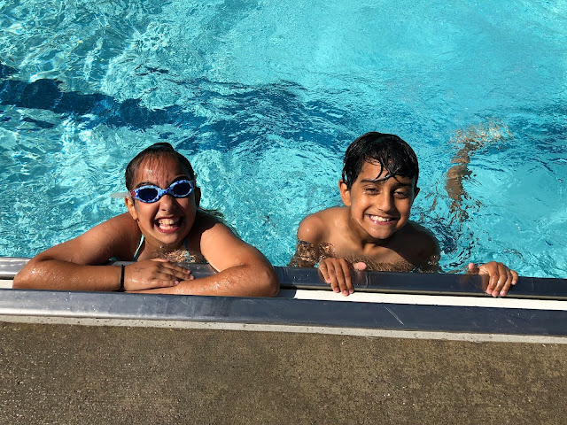 kids in pool smiling