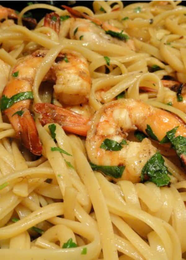 Shrimp Scampi tossed with pasta and parsley.