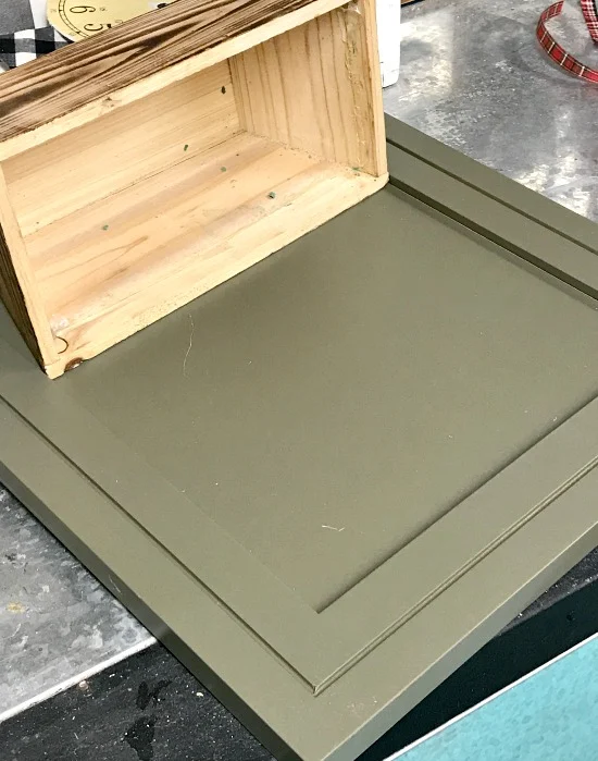 green cabinet door with wooden basket