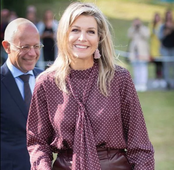 Queen Maxima wore Zara Polka dot blouse with bow detail, and burgundy ankle length wide leg high waisted leather trousers