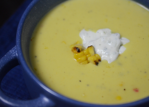 Smokey charred corn bisque with poblano crema is easy to make at home.