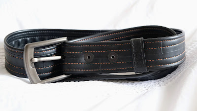 Vegan belt made out of an inner tub on a white background.