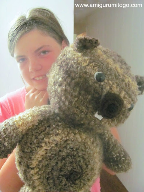 girl holding stuffed beaver toy