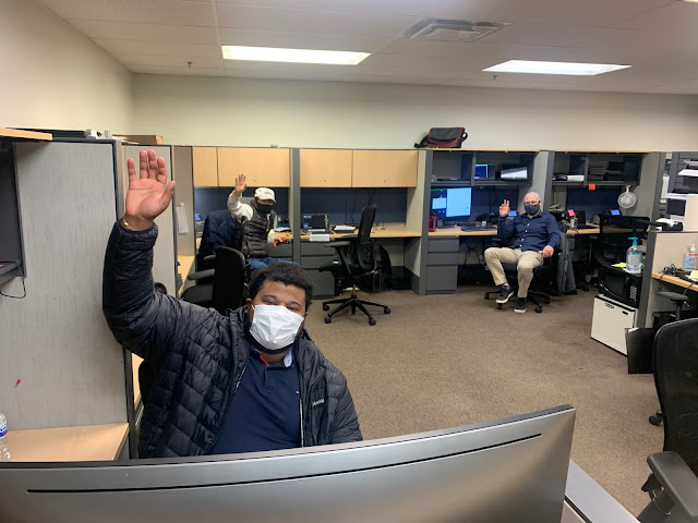 IT employees at the Help Desk waving