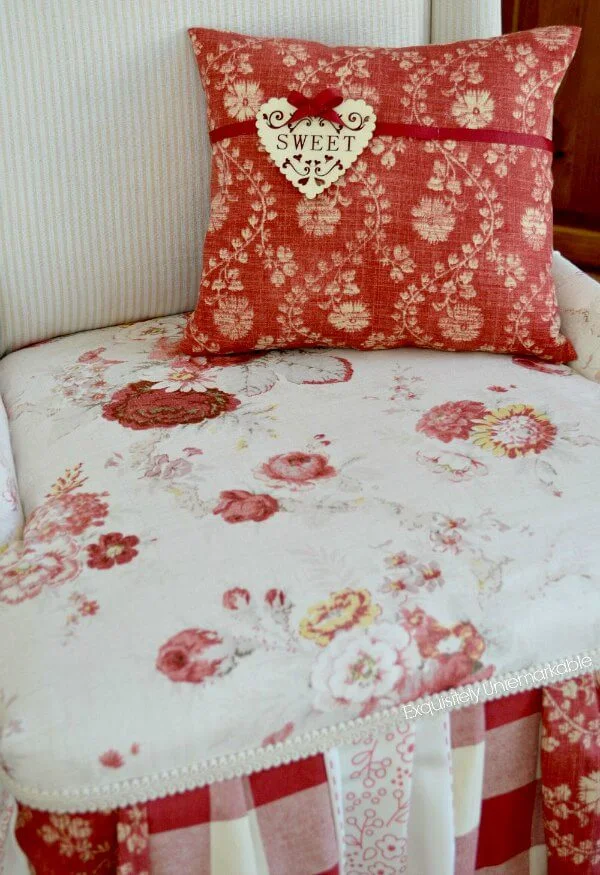 Sweet wooden tag pillow on red floral patchwork chair