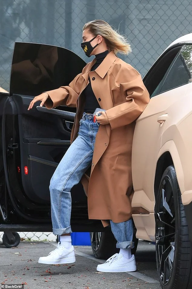 Hailey Bieber Wearing a brown trench coat