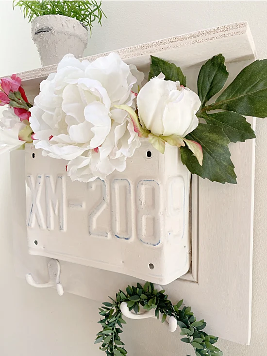 cabinet door with license plate filled with flowers