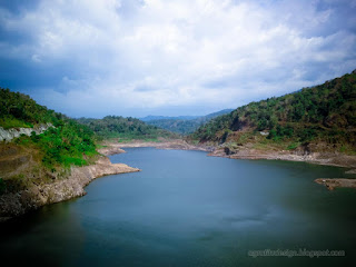 Natural Scenery Of The Dam Landscape Between The Hills In The Sunny Cloudy Day At Titab Ularan Village North Bali Indonesia
