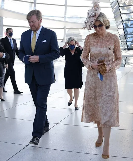 Queen Maxima wore a brown dress from Natan Edouard Vermeulen, and a leaf style hat from Berry Rutjes. Chancellor of Germany Angela Merkel