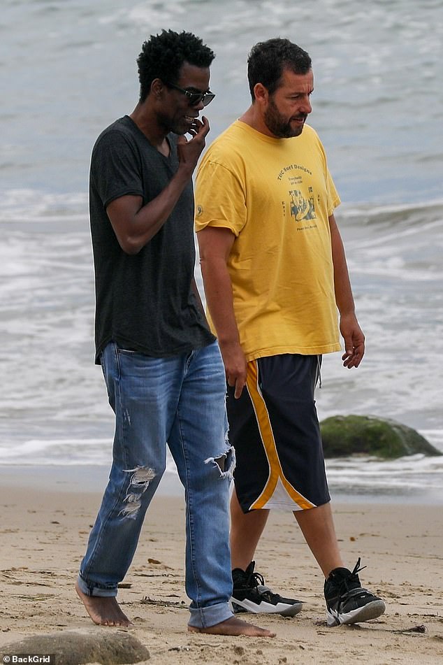 Adam Sandler and Chris Rock take an afternoon walk along the beach in