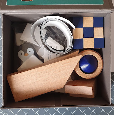 Open Box from the top showing all of the contents within Mostly wooden