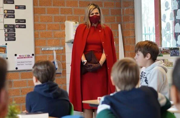 Queen Maxima wore a red coat and red sleeveless dress from Natan. Oscar de la Renta earrings