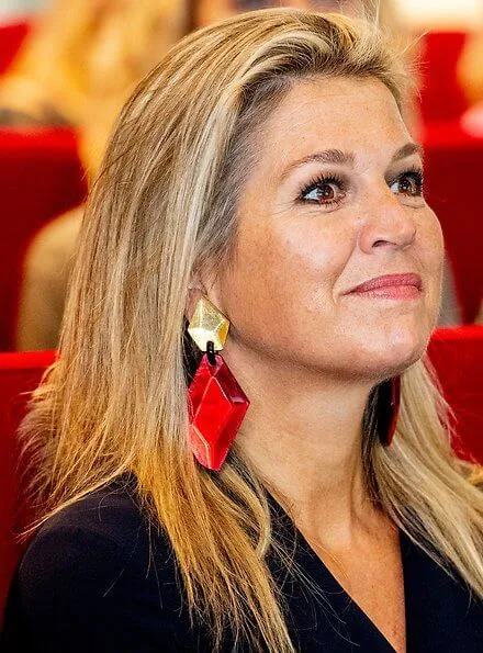 Queen Maxima wore Natan crepe jumpsuit. Queen Maxima's outfit is by Belgian fashion house Natan. red sandals and clutch