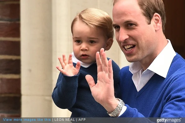 Britain's Prince William, Duke of Cambridge, and his son Prince George of Cambridge wave as they return to the Lindo Wing at St Mary's Hospital in central London