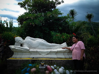 Traveler Woman In The Garden Of Sleeping Buddha Statue Outdoor At Buddhist Monastery North Bali Indonesia