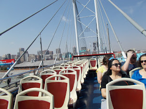 On the "Red Tour Bus" crossing over "Nelson Mandela Bridge".