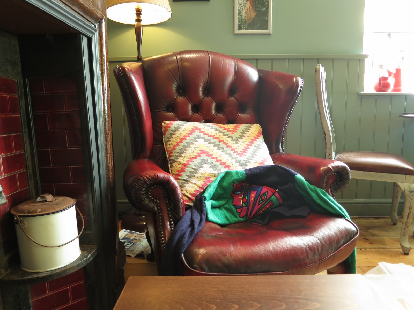 Chair with brightly coloured cushion in cafe
