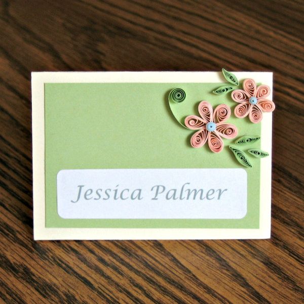 Quilled flowers decorate a place card on table