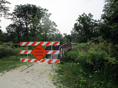 Trail closed sign on bridge