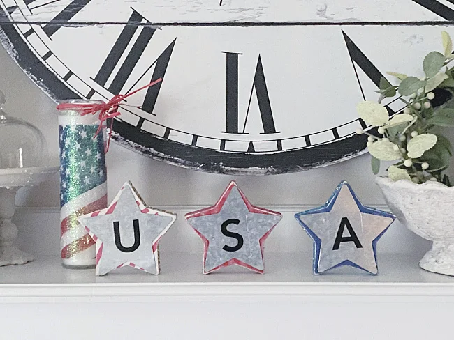 USA stars on a mantel with a clock and candle