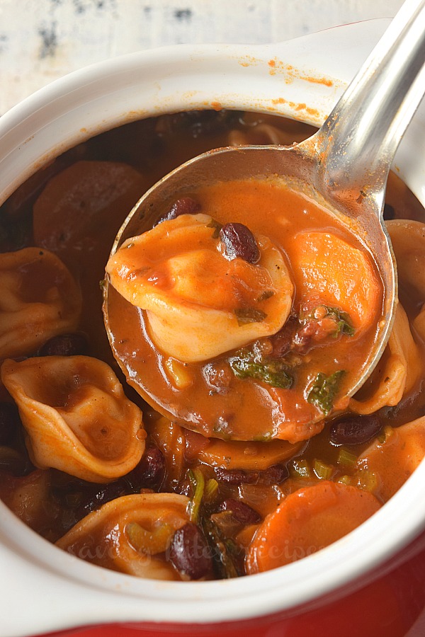 a red bowl with tortellini minestrone soup 