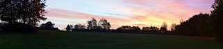 A panoramic photograph of a colourful sunrise over Harbottle Park, Byker.