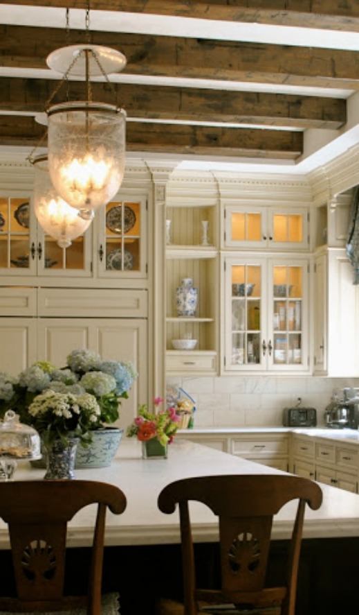 Bell jar light fixtures in elegant blue and white Enchanted Home kitchen