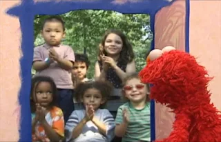 Elmo opens the door, there are kids applauding. Sesame Street Elmo's World Hands