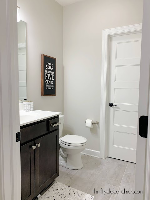 bathroom with tile dark vanity