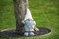 A gnome next to a tree