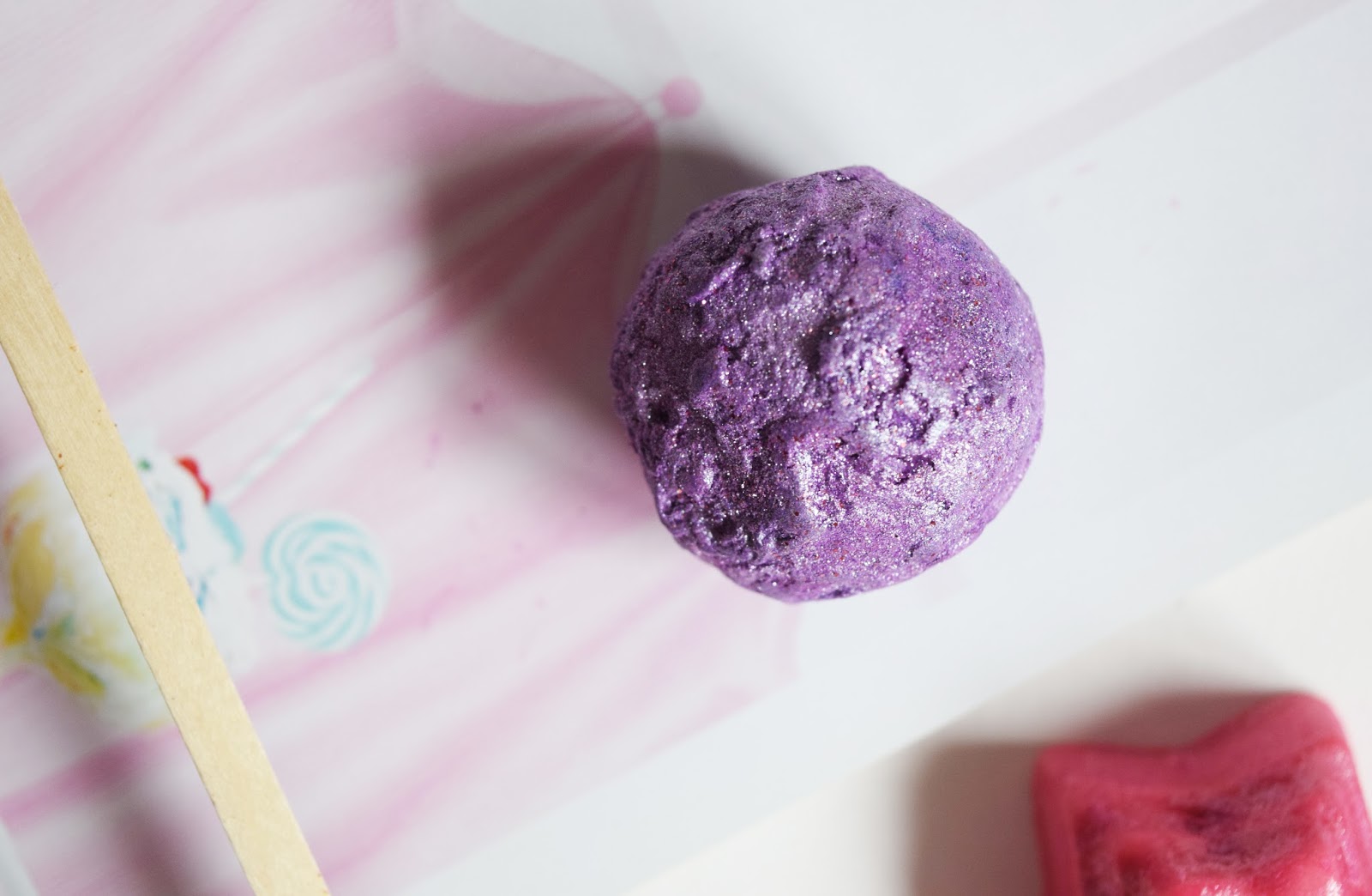 a close up shot of the purple bath oil ball