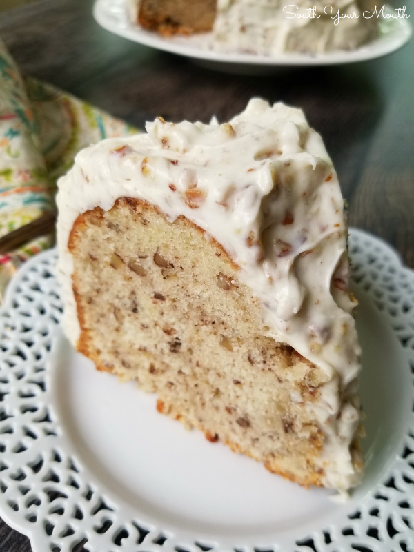 A decadent Southern pound cake recipe made with sour cream and pecans topped with an ultra creamy pecan-studded cream cheese frosting that will have folks begging for the recipe! #pecans #poundcake #creamcheesefrosting