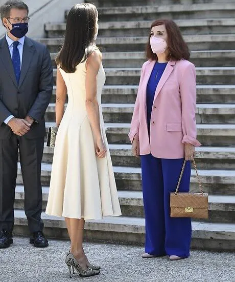 Queen Letizia wore an ivory midi dress by Spanish designer, Pedro Del Hierro, and snake printed pumps by Magrit. Gold And Roses earrings