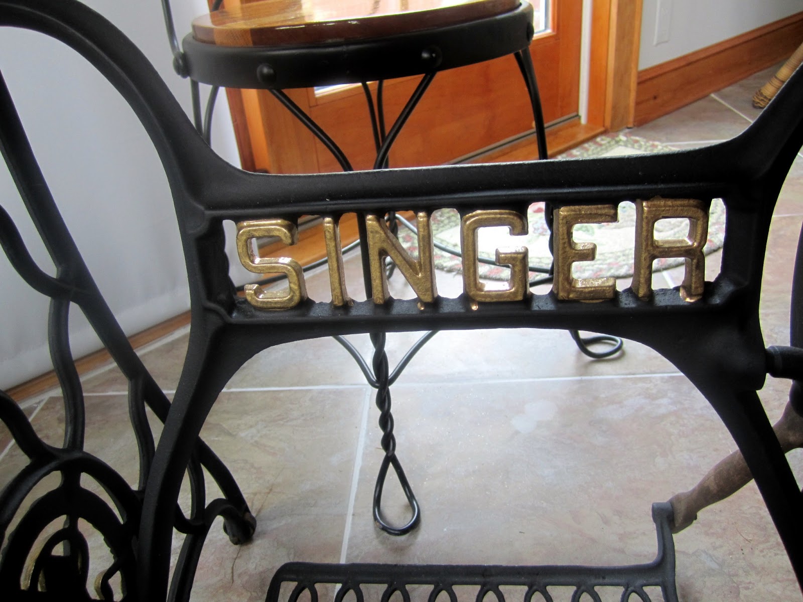 The Bear Cupboard GRANITETOPPED TABLE WITH ANTIQUE SEWING MACHINE