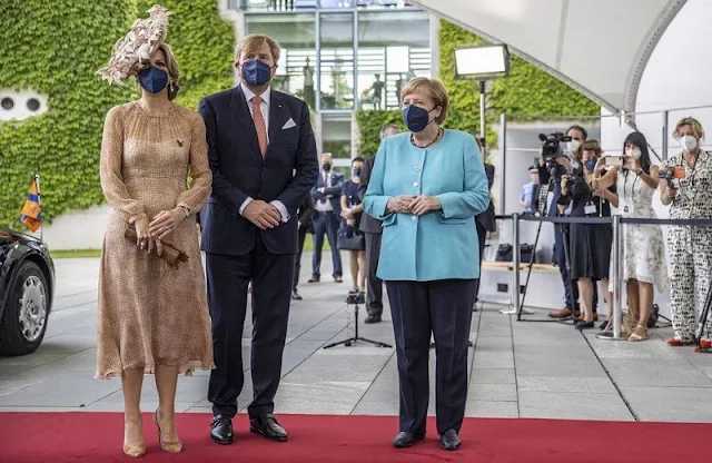 Queen Maxima wore a brown dress from Natan Edouard Vermeulen, and a leaf style hat from Berry Rutjes. Chancellor of Germany Angela Merkel